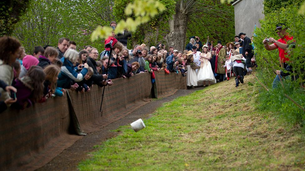 Our relationship with cheese can be quite odd at times, including festivals that roll wheels of it down hills (Credit: Paul Gapper/Alamy)