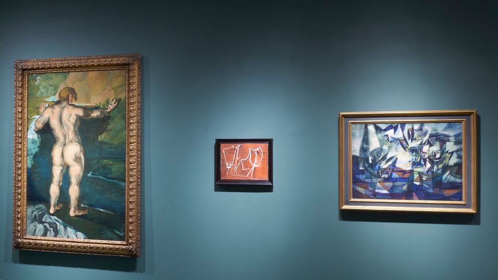 Löwenstein's 1939 Composition (right) appears near paintings by Paul Cézanne (Bather and Rocks, left) and Pablo Picasso (Group of Characters, centre) (Credit: Steven Paneccasio)