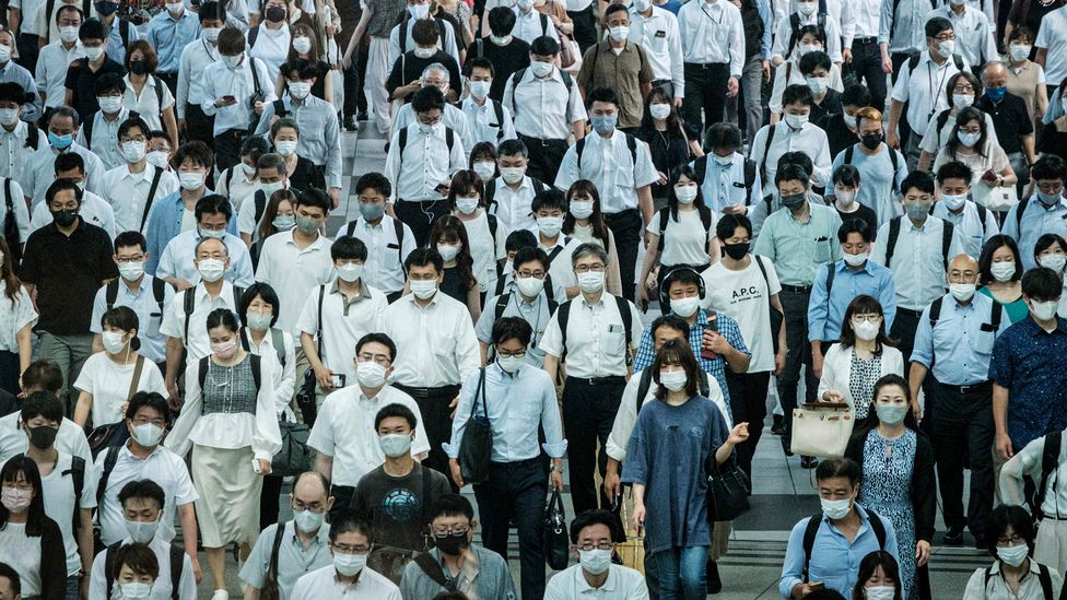 Crowd of Tokyo train commuters in masks (Credit: Yasuyoshi Chiba/AFP/Getty Images)