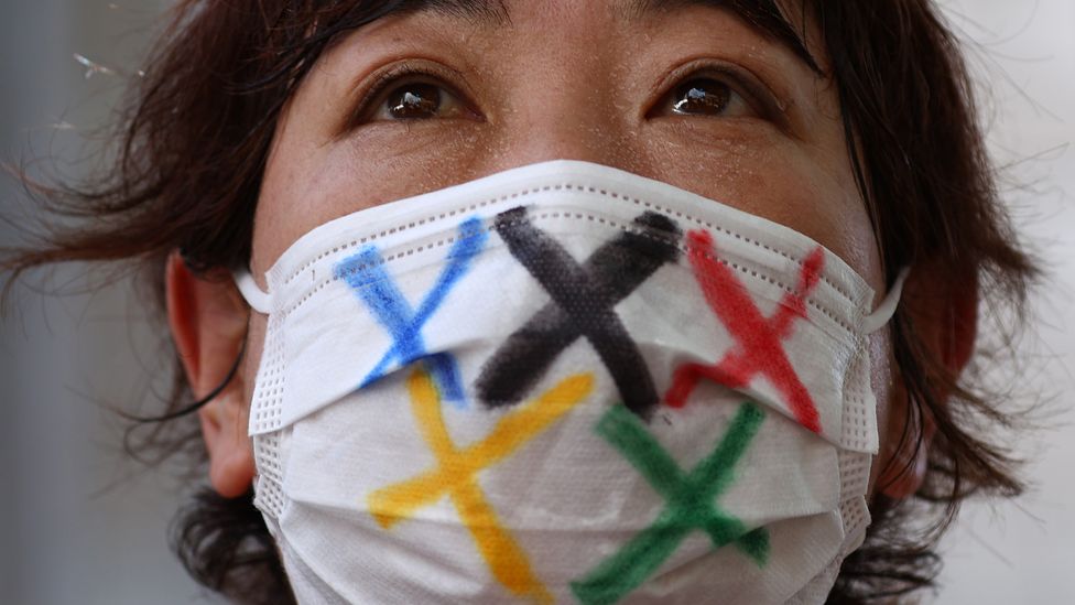 Fan wearing mask with Olympic logo (Credit: Edgar Su/Reuters/Getty Images)