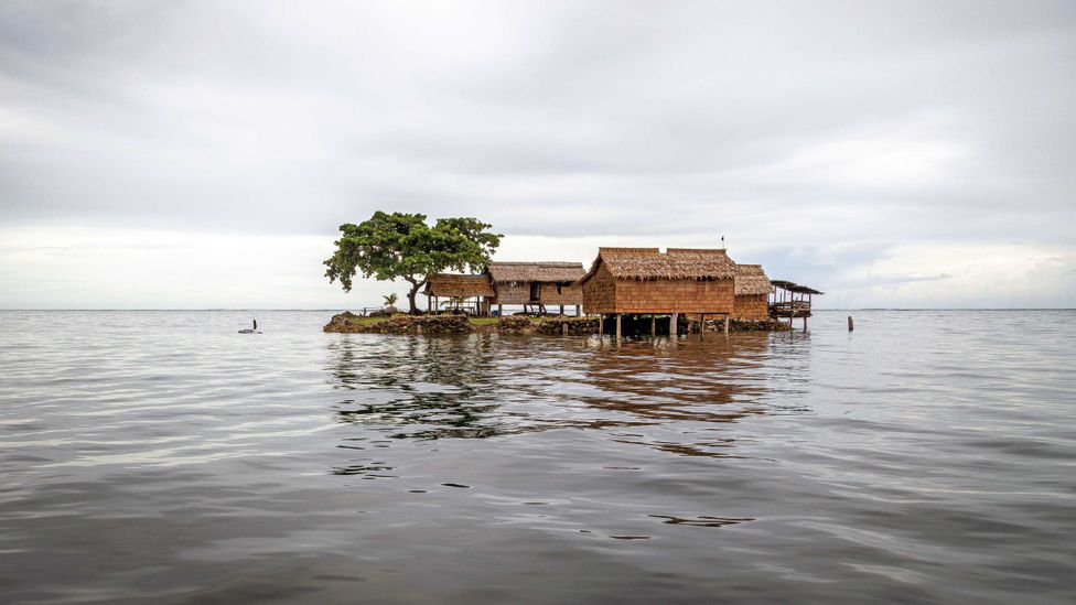 A traditional house on an artificial island in Lau Lagoon in the Solomon Islands (Credit: Alamy)