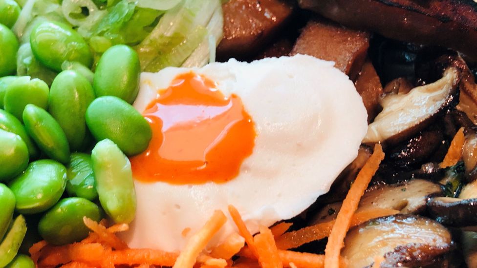 A vegan soft boiled egg in a bowl with seitan and vegetables (Credit: Getty Images)