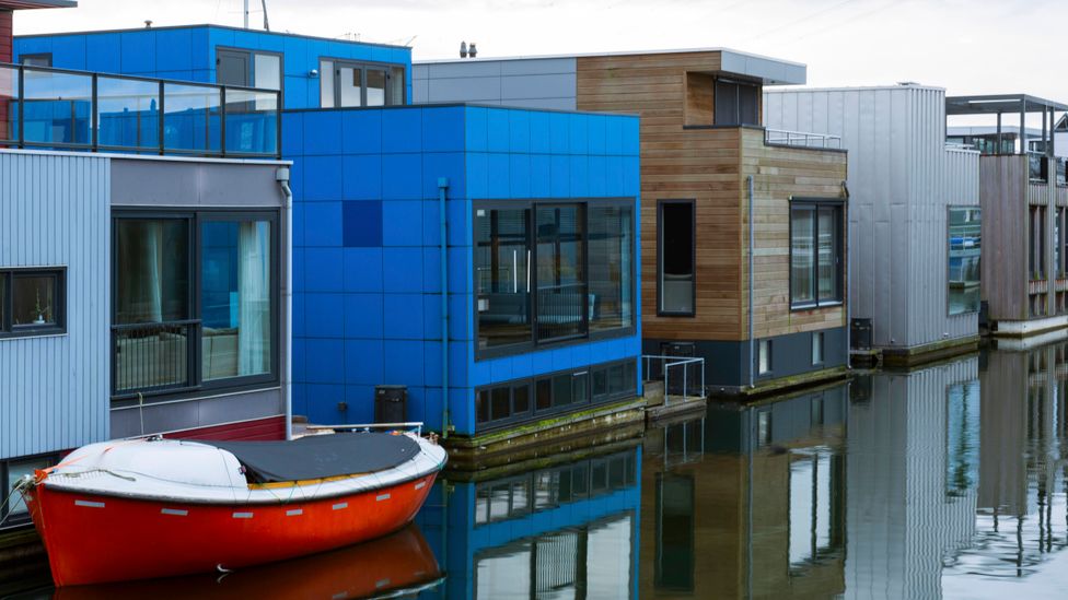 The Netherlands' floating houses are attached to a pillar, and can bob up and down the pillar according to the water level (Credit: Getty Images)