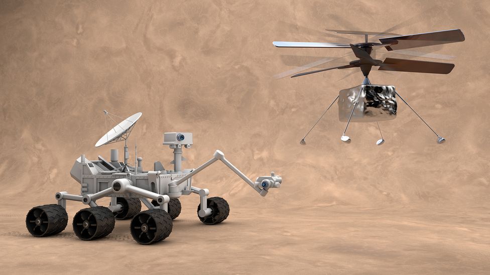A small helicopter like Ingenuity (right) offers a different way of mapping alien worlds to the painstaking approach taken by rovers like Curiosity (Credit: Devromb/Getty Images)