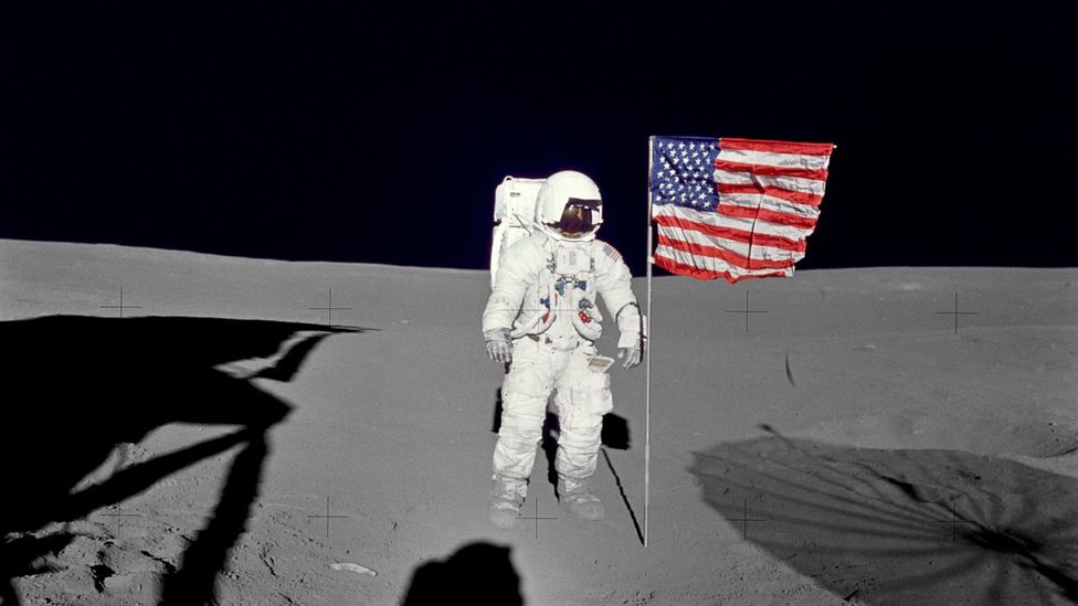 Astronaut standing by flag on Moon (Credit: Nasa)