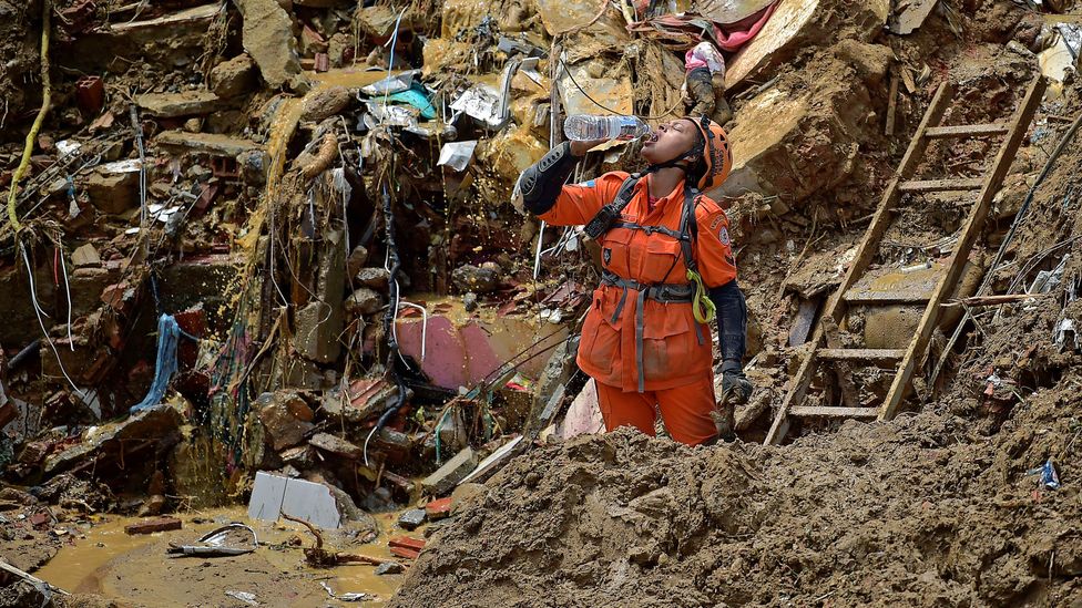 A rescue worker looks for survivors after a mudslide in Petropolis, Brazil in February 2022. (Credit: C.SOUZA/Getty)
