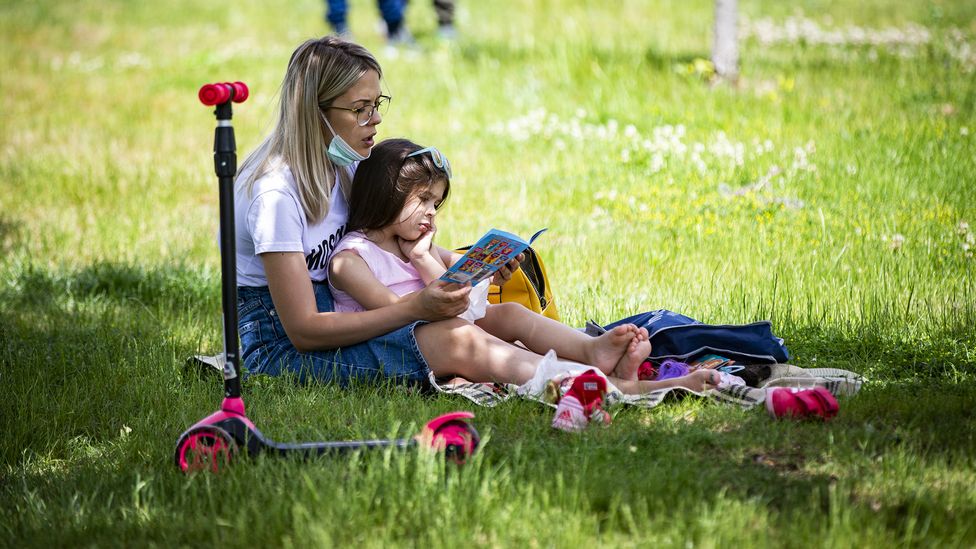 Reading together, like this mother and child in a park in Turkey, can boost children's language and literacy skills (Credit: Ozge Elif Kizil/Anadolu Agency via Getty Images)
