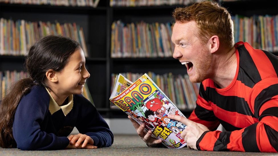 World Book Day celebrates the joy of reading, and has become increasingly popular. Here, British Olympic Gold Medallist Greg Rutherford joins in (Credit: Matt Alexander/PA Wire)