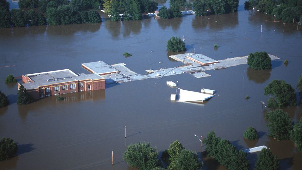 Valmeyer High School and surrounding houses were submerged in water during the flood of June 1993 in Valmeyer, Illinois (Credit: Daybreak Imagery/Alamy)