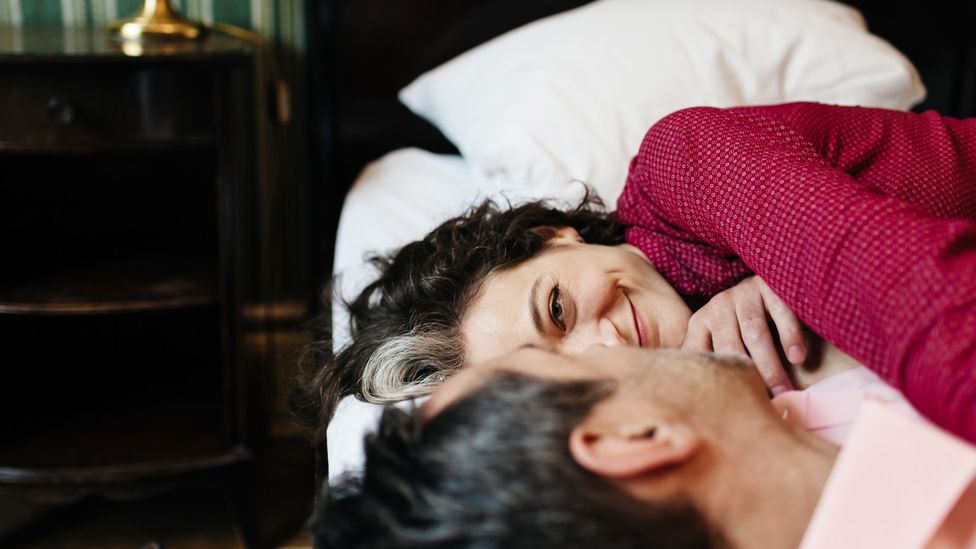 A couple lying in bed together