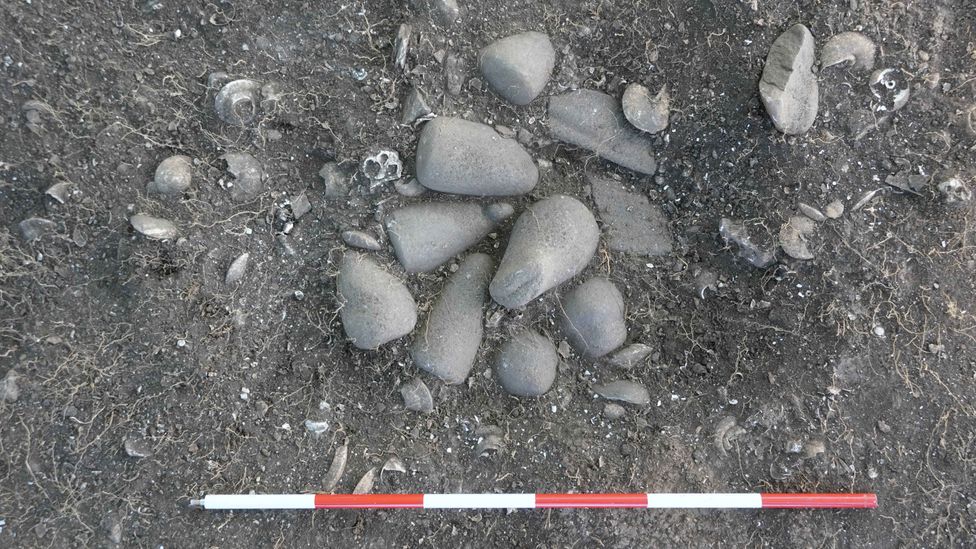 A ground-breaking find was a small ritual well with 12 polished stone pestles buried inside (Credit: Francesco Genchi/Sapienza University of Rome) A ground-breaking find was a small ritual well with 12 polished stone pestles buried inside (Credit: Francesco Genchi/Sapienza University of Rome)