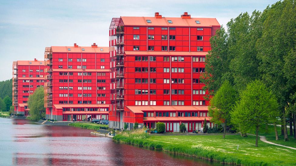 The Regenboogbuurt in Almere features brightly coloured residential buildings including Rode Donders, which echo Dutch grain silos that once dotted the landscape (Credit: Alamy)