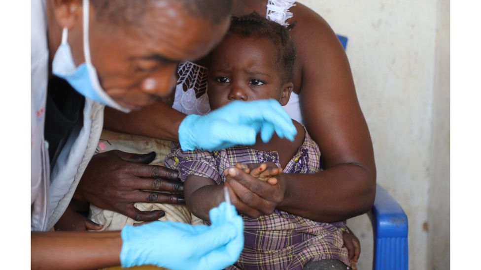 Emmanuel Poler, a community health worker in Grand Gedeh county, tests a child for malaria (Credit: Peter Yeung)