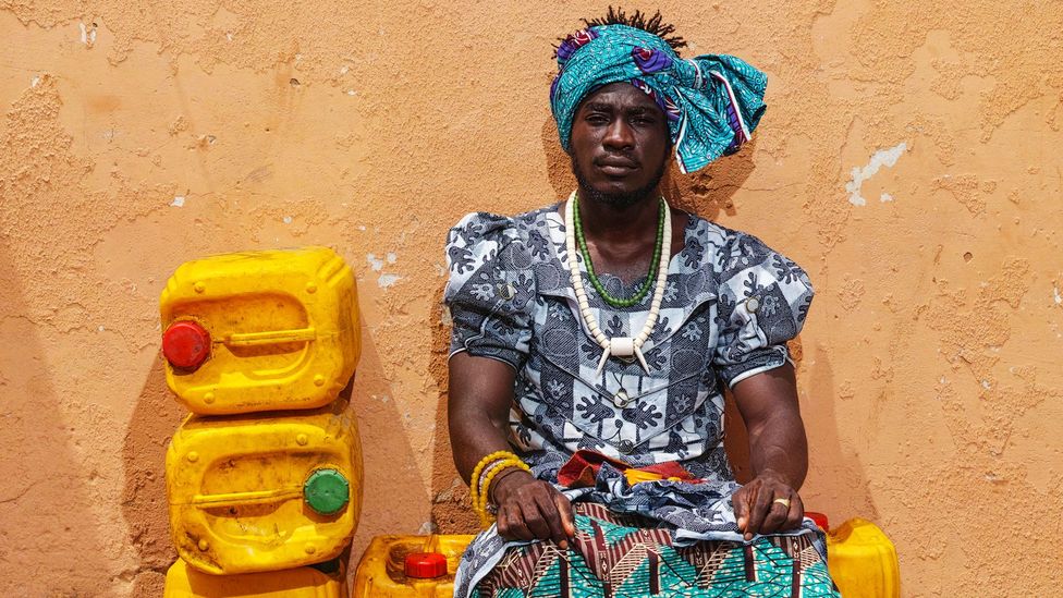 Serge Attukwei Clottey's project My Mother’s Wardrobe saw him walk the streets of Accra wearing one of his late mother's patterned dresses (Credit: Nii Odzenma/ Gallery 1957)