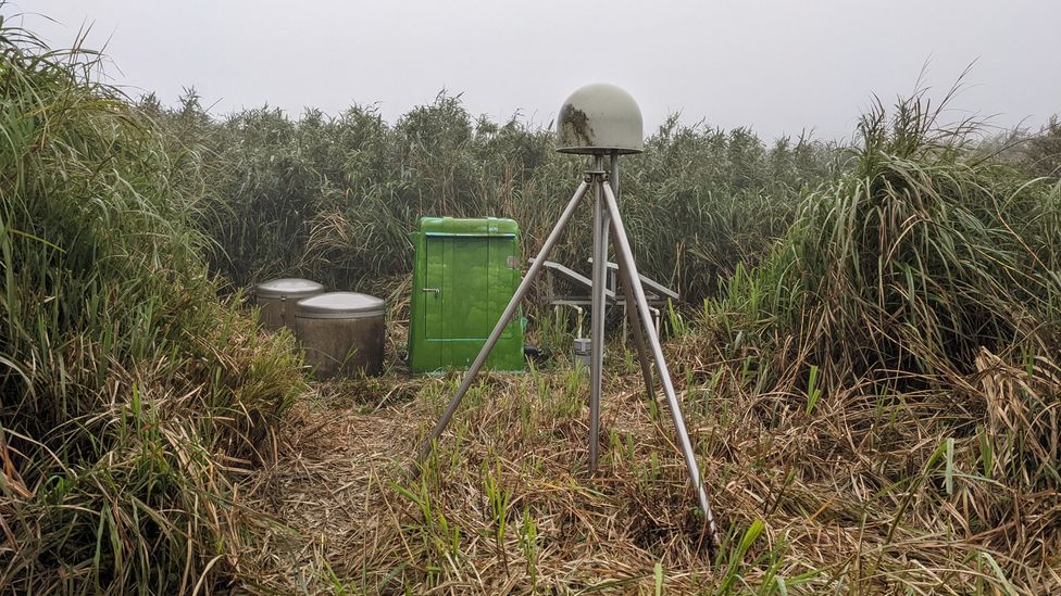 Monitoring equipment in Xiaoyoukeng features a GPS sensor (green dome), underground seismometer (marked by two silver drums on the left) and tiltmeter (Credit: Dinah Gardner)