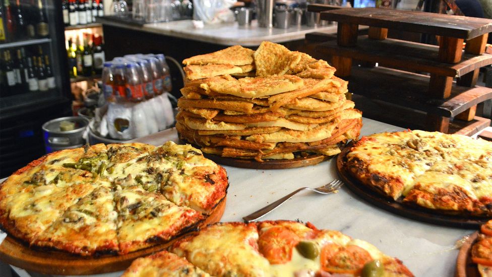 In Bueno Aires, pizza is often served with chickpea pancake known as "fainá" (Credit: Amy Booth)