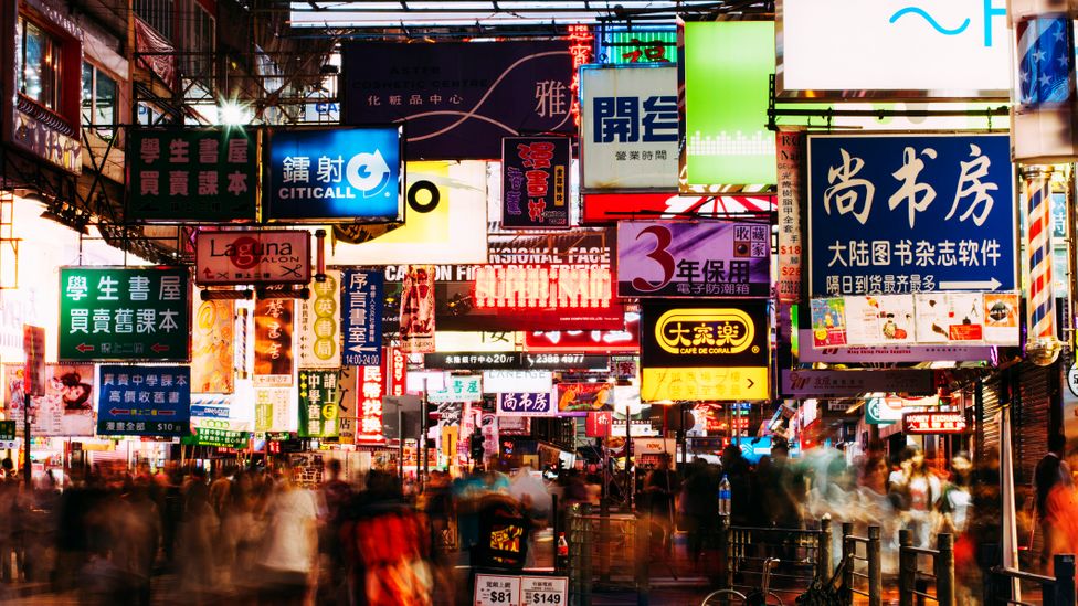 Once home to ramshackle squatter communities, Kowloon is now a densely populated, neon-lit urban area (Credit: Gary Yeowell/Getty Images)