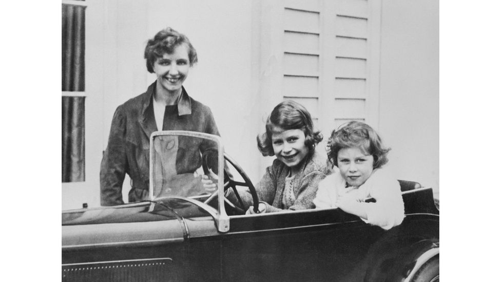 The young Princesses Elizabeth and Margaret with their governess, Marion Crawford, whose book The Little Princesses scandalised the palace (Credit: Getty Images)