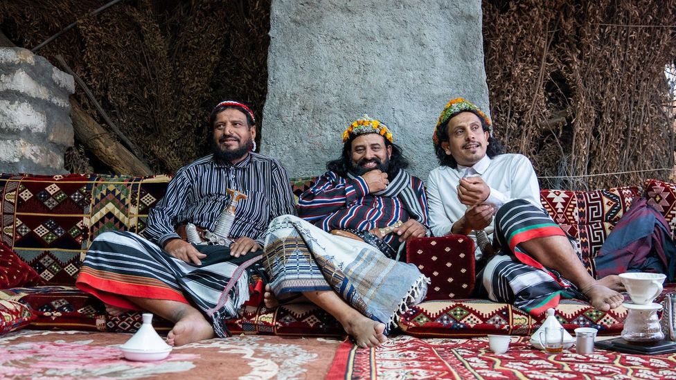 Social media sensation Al-Raithi (right) gave us a joyous greeting and immediately prepared coffee in small cups, served out of a long, ornate silver pot (Credit: Matt Reichel)