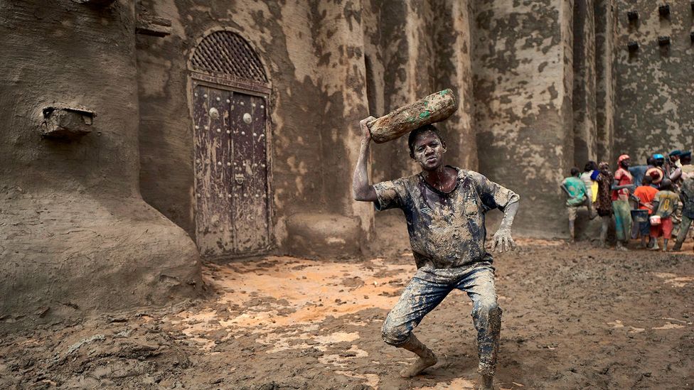 Every year all the residents of Djenné, Mali, gather to repair and reclay the Great Mosque, the largest mud building in the world (Credit: Michele Cattani / Getty Images)