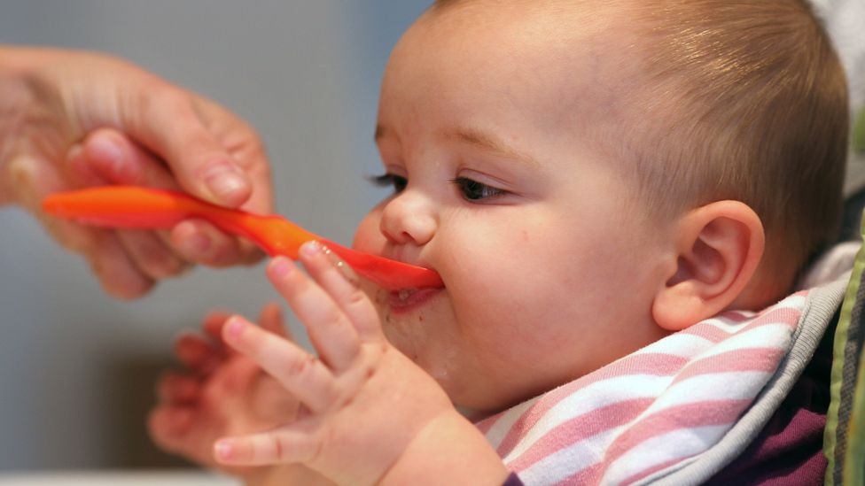 Feeding a baby many different foods during their first year of life is thought to help prevent allergies (Credit: Getty Images)