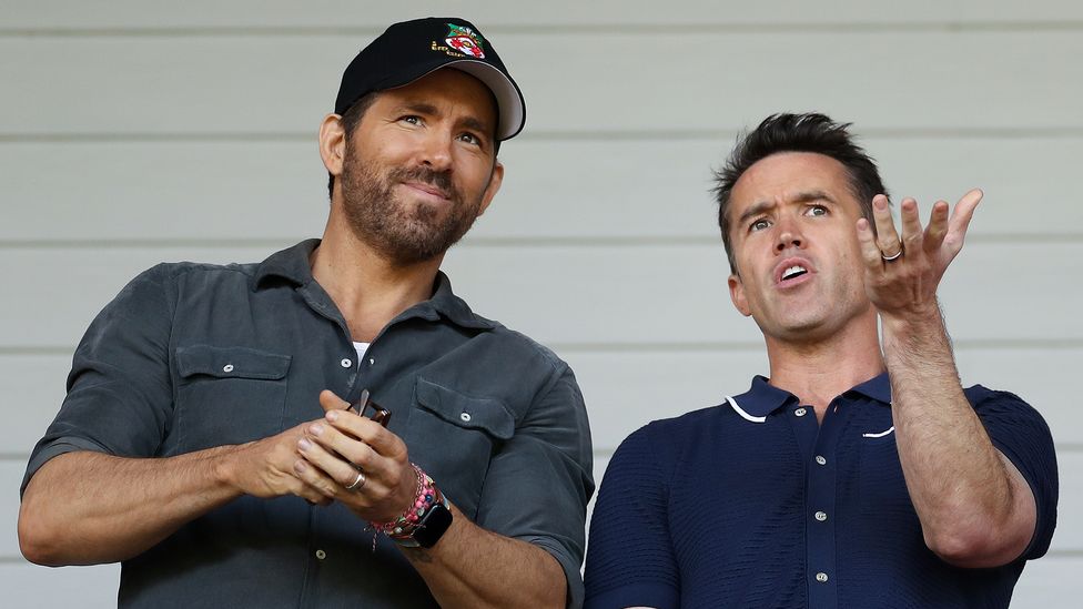 Ryan Reynolds and Rob McElhenney at a Wrexham match (Credit: Lewis Storey/Getty Images)