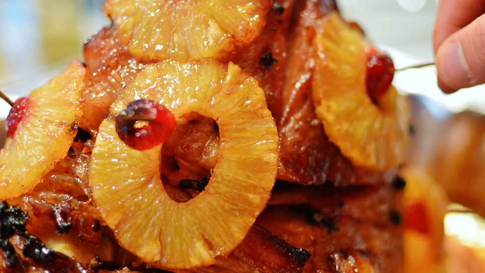 Pineapple’s sweetness has often been seen as a foil for the saltiness of cured ham (Credit: Image Kit/Getty Images)