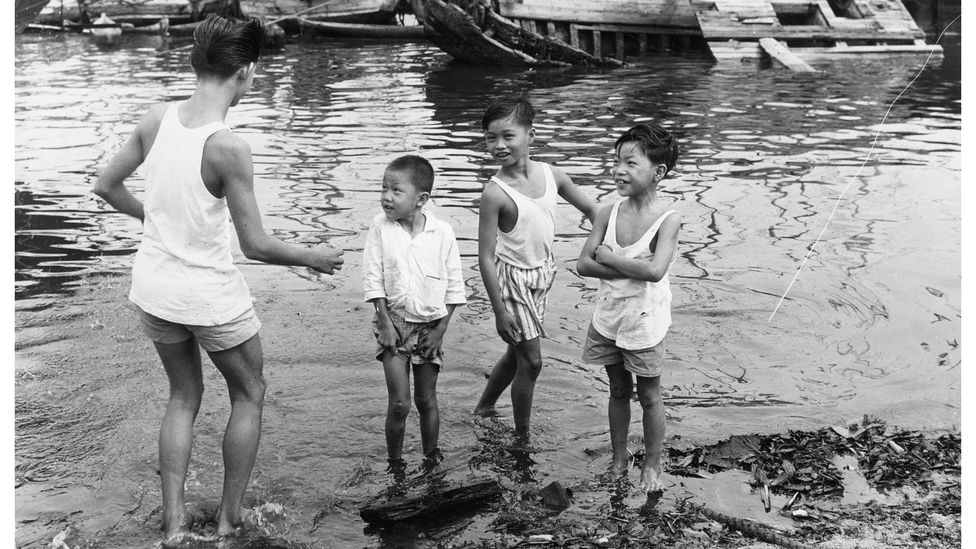 Singaporean children play by the harbour in the early 1960s. As the country became wealthier, children began spending more and more time indoors (Credit: Getty Images)