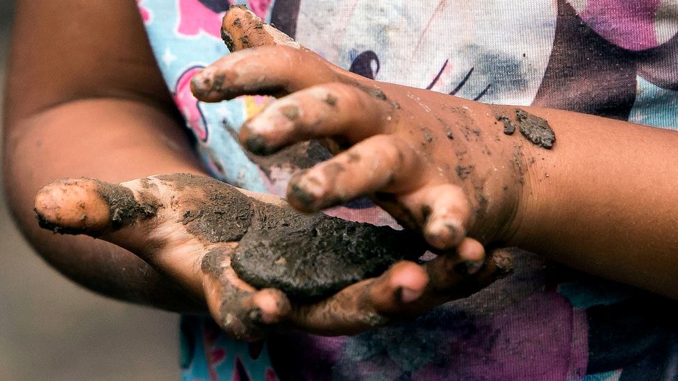 Kneading materials like mud or sand can help children develop the way their senses and movement interact (Credit: Getty Images)