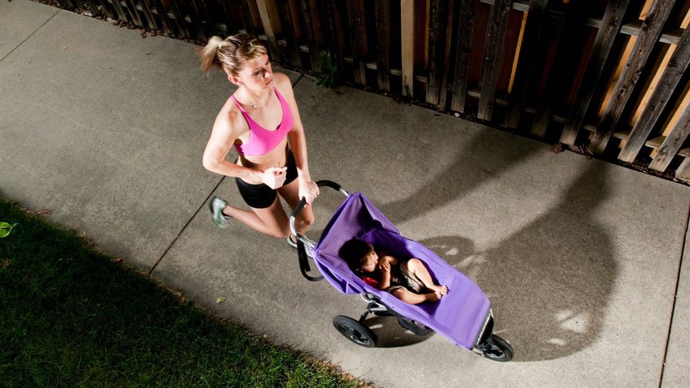 A woman running with a stroller