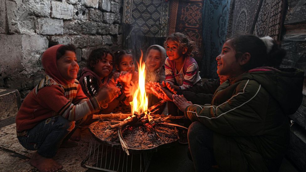 In many homes around the world, including those in developed nations, burning solid fuel like wood or coal is the only source of warmth (Credit: Mustafa Hassona/Getty Images)