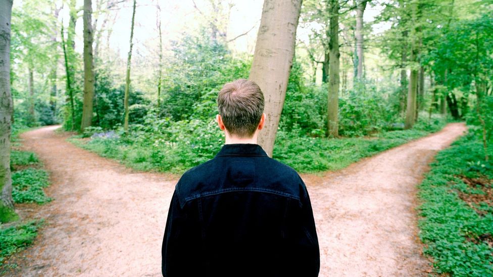 A man staring at two possible paths