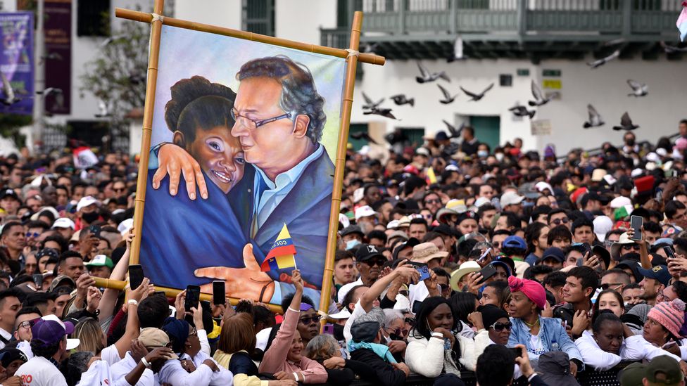 Supporters of Colombia's new President, Gustavo Petro, hold a painting depicting him and his vice president Francia Marquez (Credit: Guillermo Legaria/Getty Images)