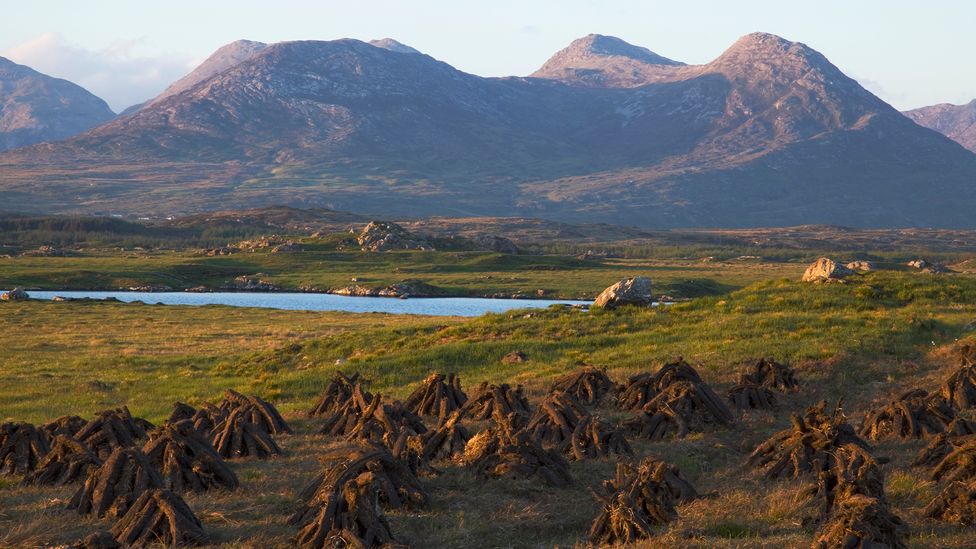 Many locals still hand-cut peat in the shadow of the Twelve Bens mountains (Credit: Peter Zoeller/Getty Images)