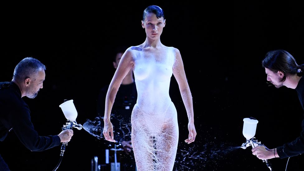 In a dramatic stunt, Parisian brand Coperni sprayed a dress made of a liquid fabric on to the body of model Bella Hadid (Credit: Getty Images)