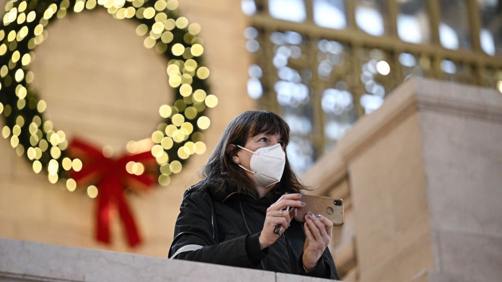 A woman wearing a mask in New York City in December 2022 (Credit: Getty Images)