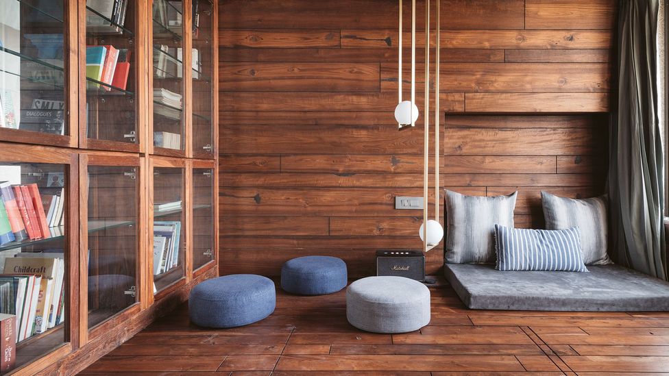 The warm tones and textures of MD Apartment are achieved through the use of re-purposed teak floorboards (Credit: Ishita Sitwala/ The Fishy Project)