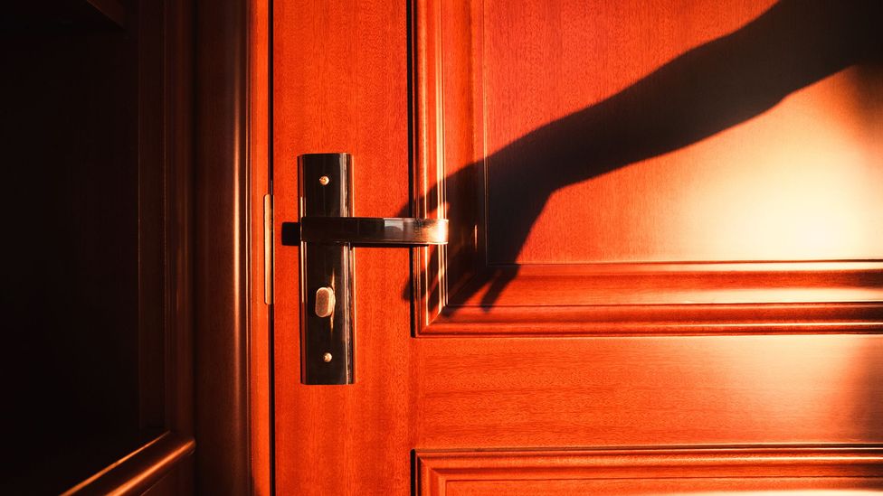 Shadow reaching for door handle (Credit: Getty Images)