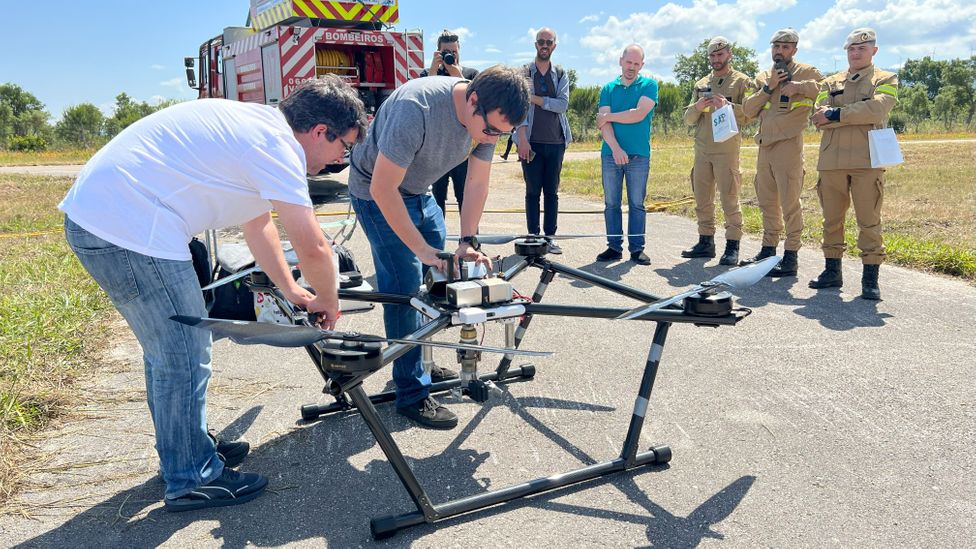 Rafael Batista and his crew dismantle the firefighting drone (Credit: April Reese)