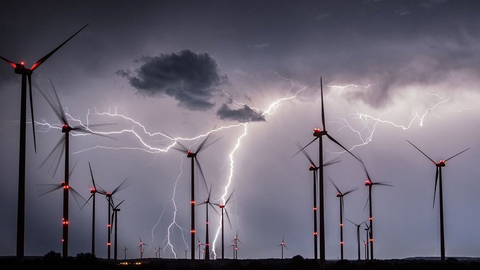 Lightning strikes behind wind turbines in Germany (Credit: Getty Images)