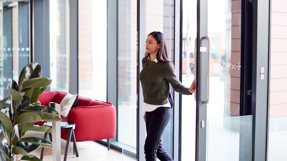 woman walking into office for her job after great resignation