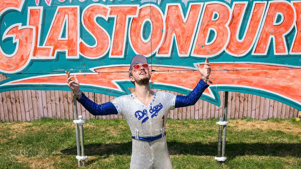 An Elton John fan at this year's Glastonbury Festival, paying homage to his iconic sequinned baseball suit (Credit: Getty Images)