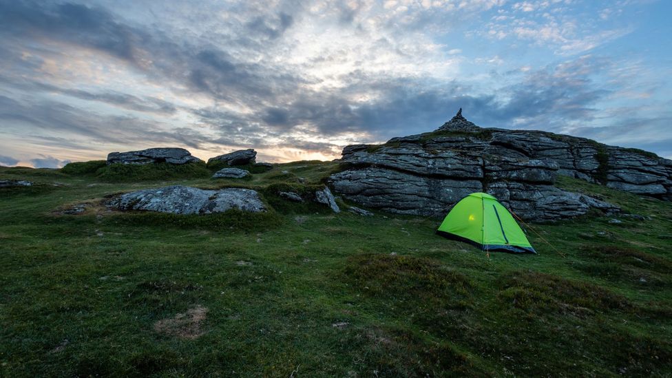Single person tent under sunset skies on Dartmoor National Park