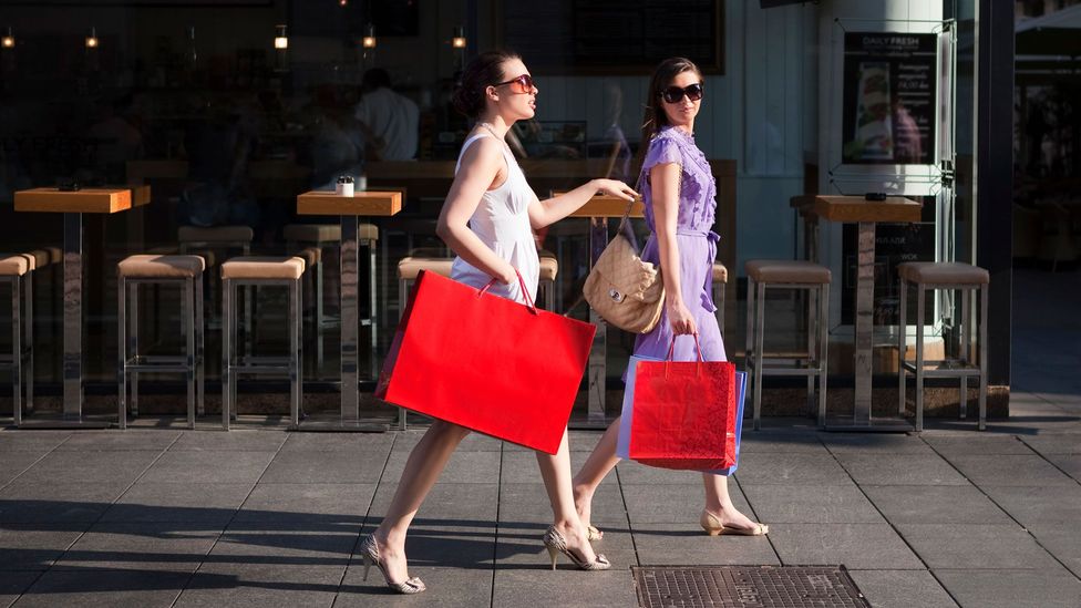 Women with red shopping bags