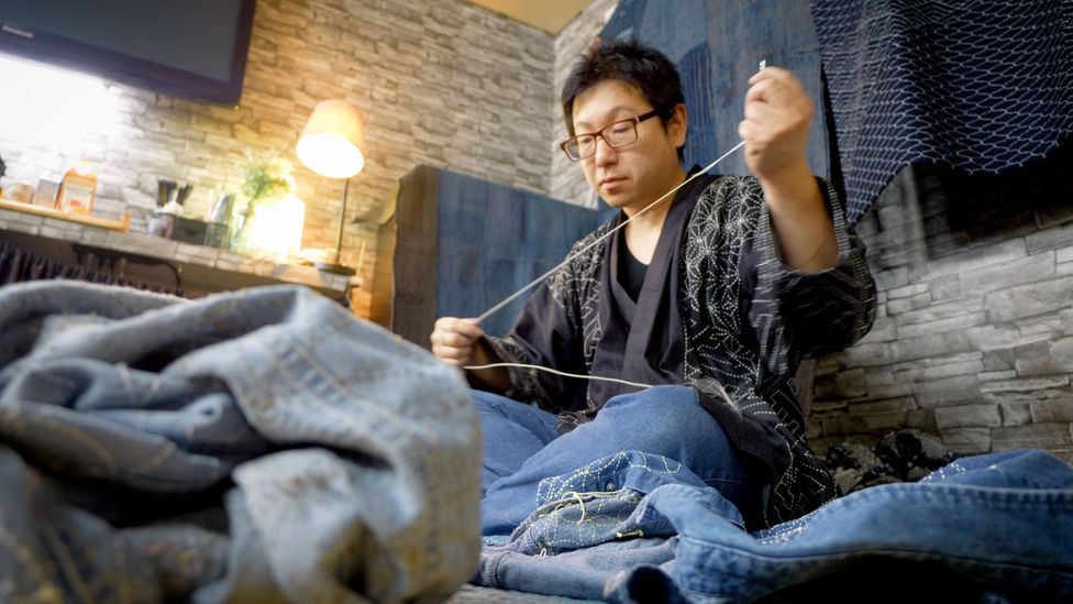 Atsushi Futatsuya of Upcycle Stitches sewing in his sashiko workshop