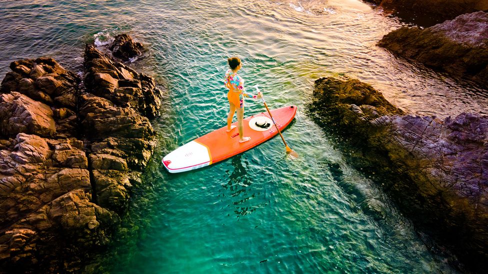 Lai recommends stand up paddleboarding as a way to explore Hong Kong's diverse landscapes (Credit: Patchareeporn Sakoolchai/Getty Images)