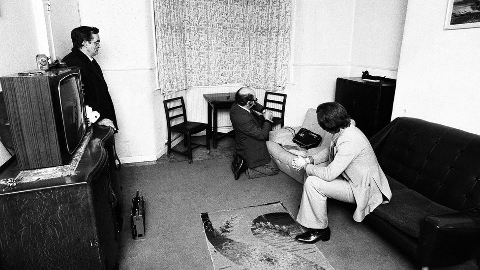 Paranormal investigator Maurice Grosse (pictured centre) spent months at the house, making audio recordings among other things (Credit: Alamy)