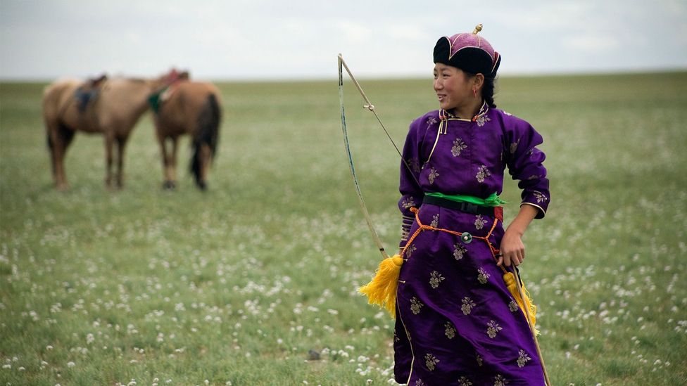 Girl in traditional attire with bow and arrow