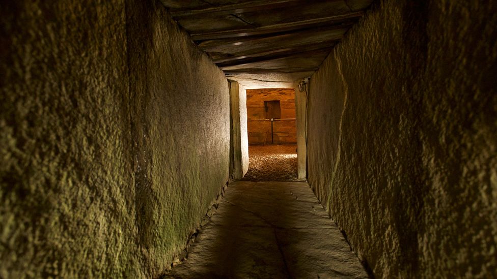 The long, low entrance passage to the tomb was designed to align with the setting of the midwinter sun (Credit: Historic Environment Scotland - HES Archives)
