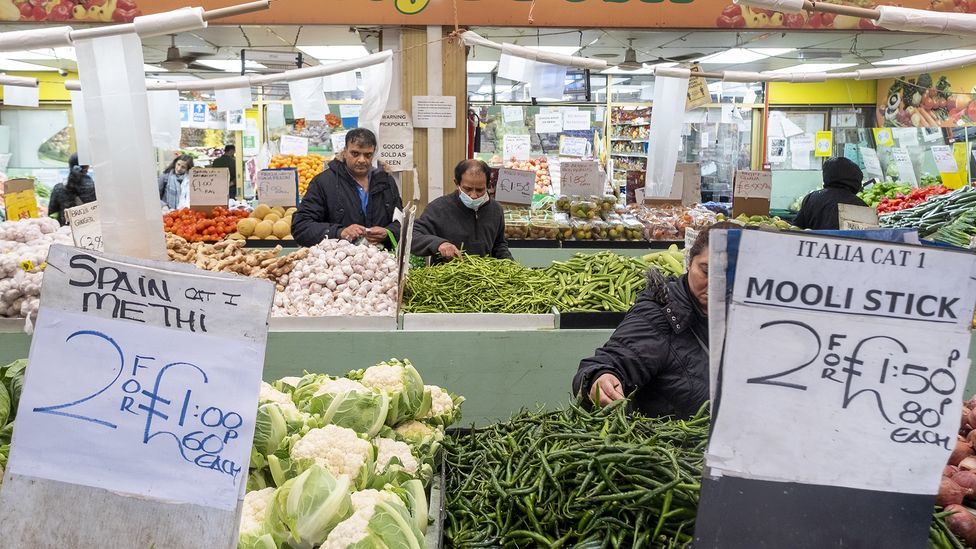 Signs showing discount prices for buying two items at a vegetable market stall (Credit: Getty Images)